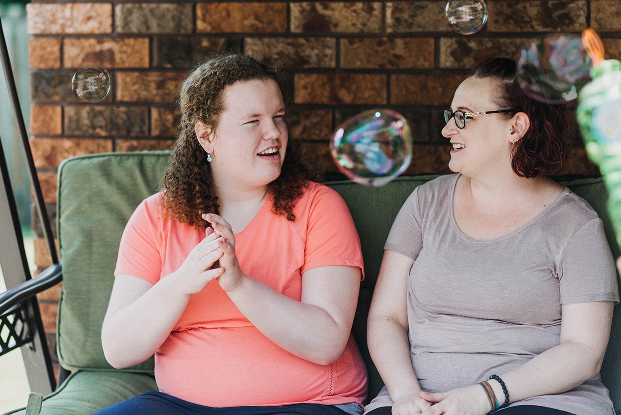 Girls sitting on a chair swing